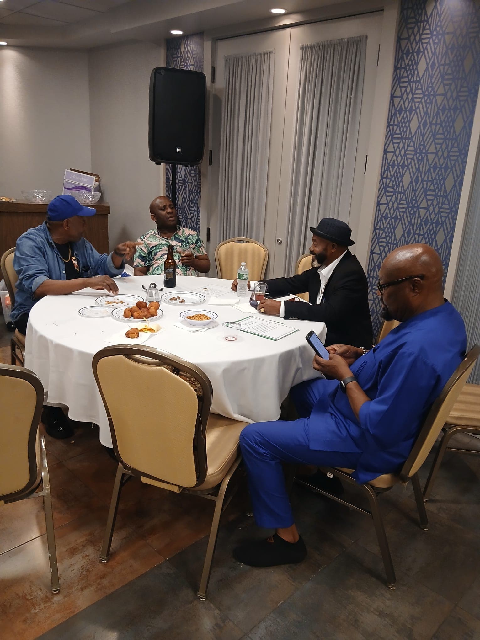Members seated around a table during a break