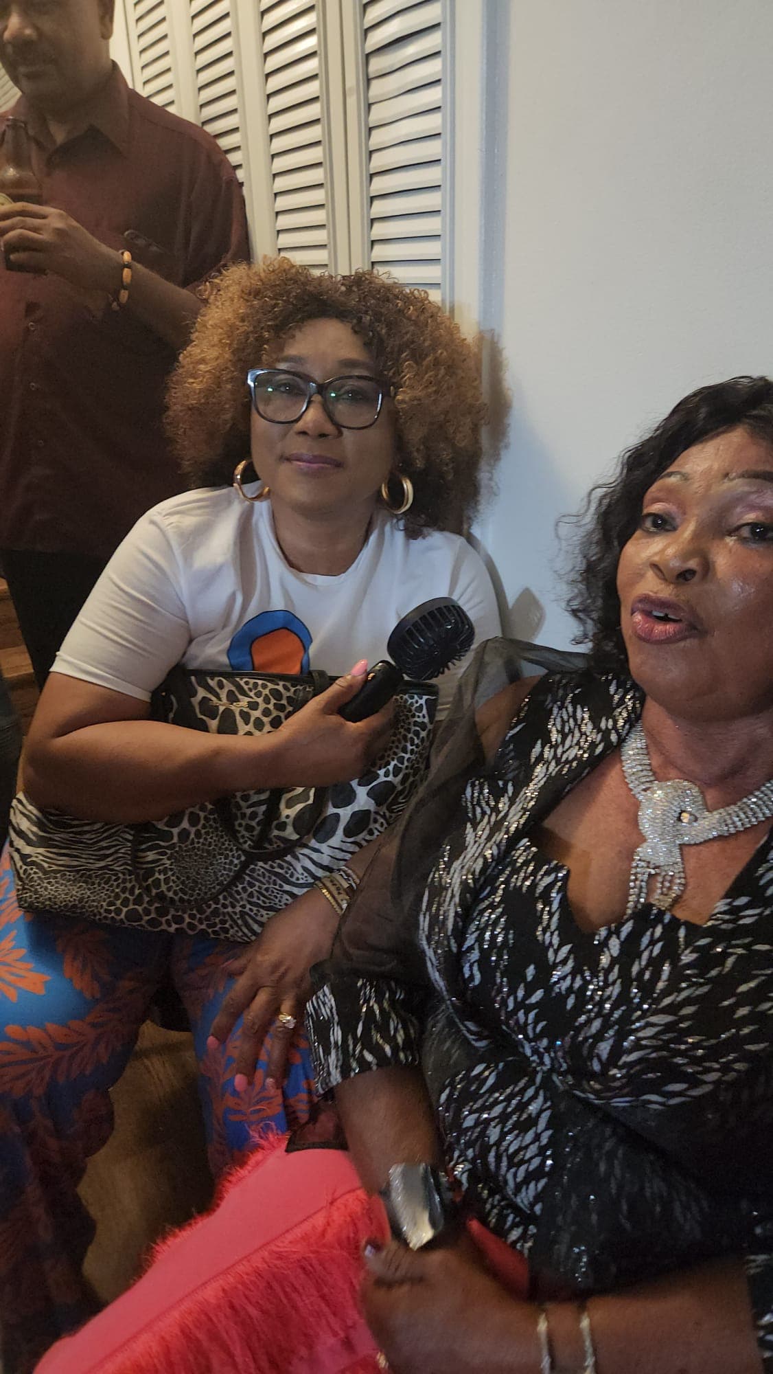 Women sharing a moment with a microphone