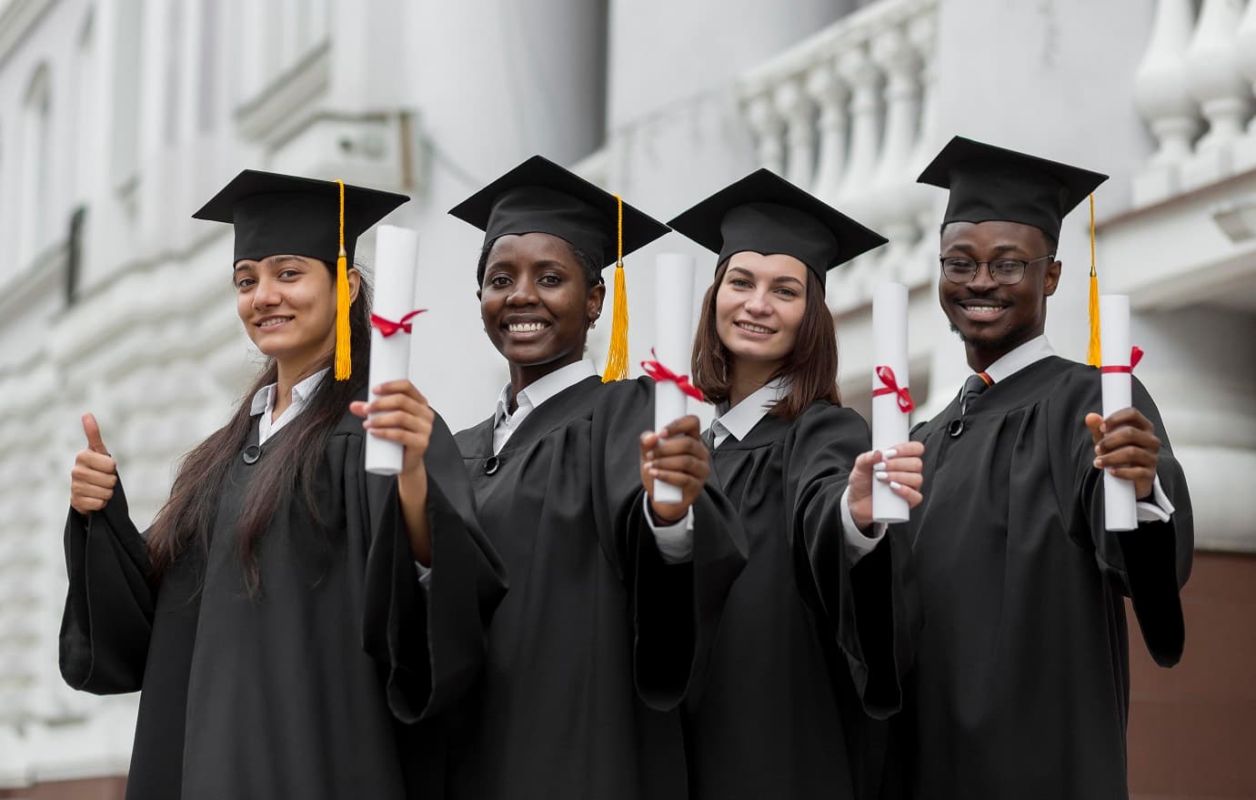 Graduating students holding their diplomas